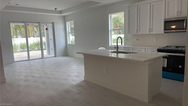 View of kitchen and great room with tray ceiling | Image 9