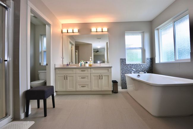 Bathroom with double vanity, a freestanding bath, and a shower stall | Image 26