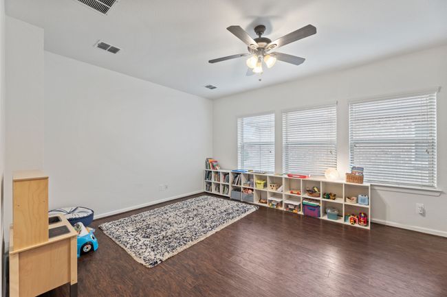 Rec room featuring a ceiling fan, wood finished floors, and baseboards | Image 24