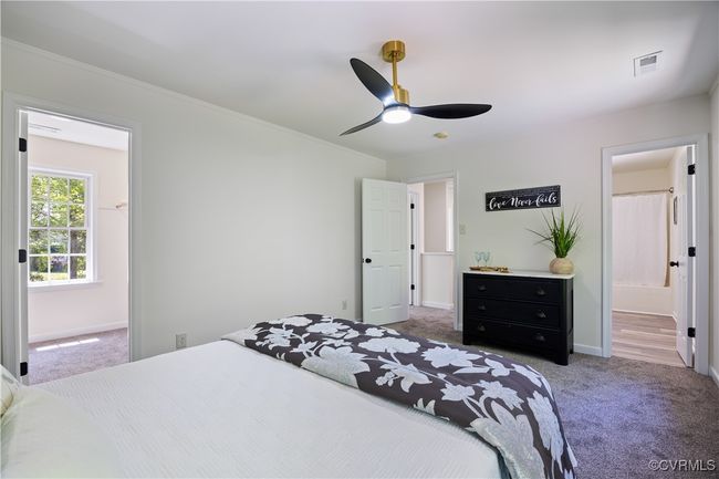 Bedroom with visible vents, baseboards, a ceiling fan, carpet floors, and ornamental molding | Image 23