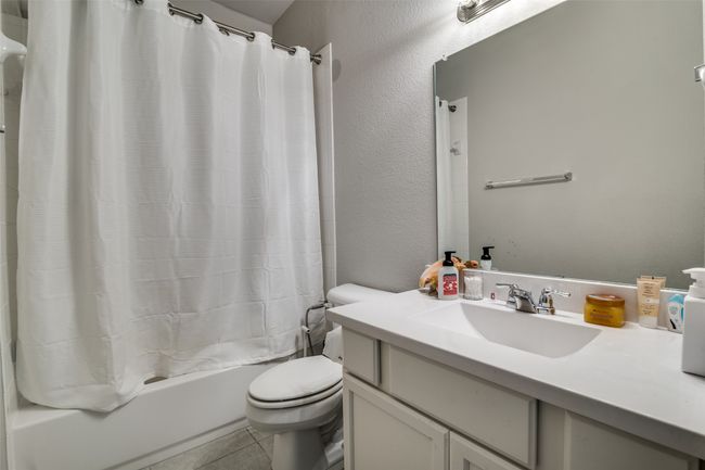 Bathroom featuring vanity, shower / bathtub combination with curtain, and tile patterned flooring | Image 22