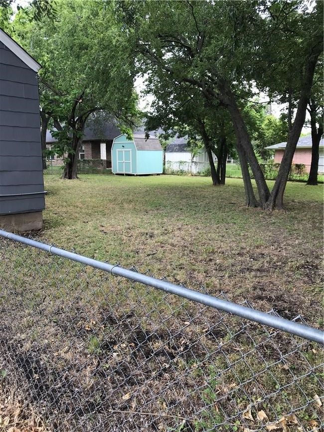 View of yard featuring a storage shed | Image 15