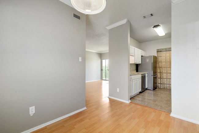 View from dining area into kitchen and living room. | Image 5