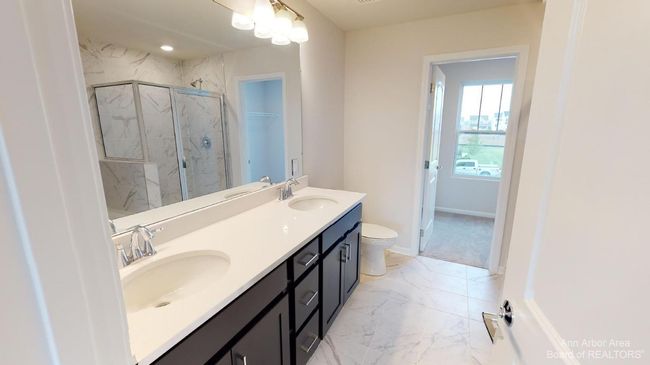 Upper level primary suite bathroom. | Image 17