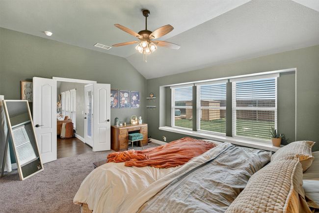 Carpeted bedroom with lofted ceiling and ceiling fan | Image 24