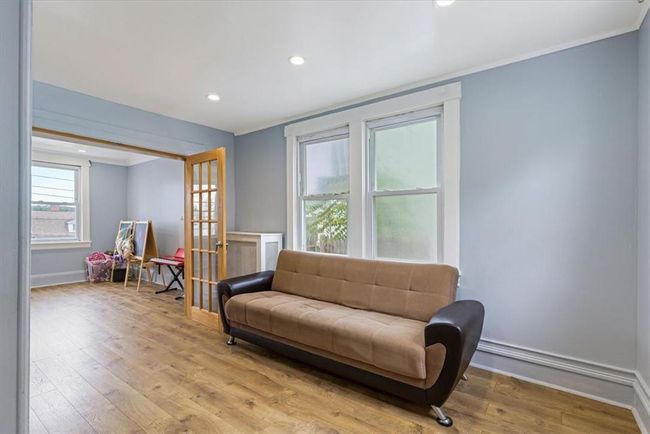 Sitting room with light hardwood / wood-style flooring and crown molding | Image 9