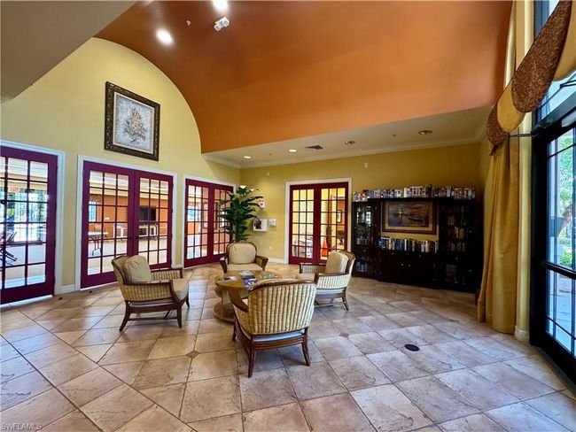 Sitting room with baseboards, high vaulted ceiling, recessed lighting, french doors, and crown molding | Image 39