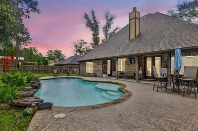 Private pool with large tanning ledge and rock water feature. | Image 3