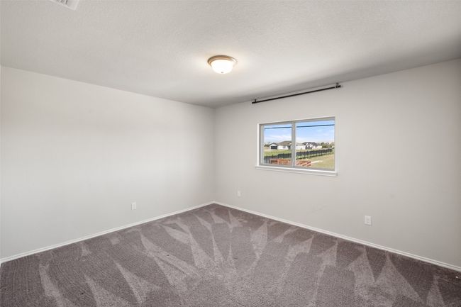Spare room featuring baseboards, carpet, and a textured ceiling | Image 16