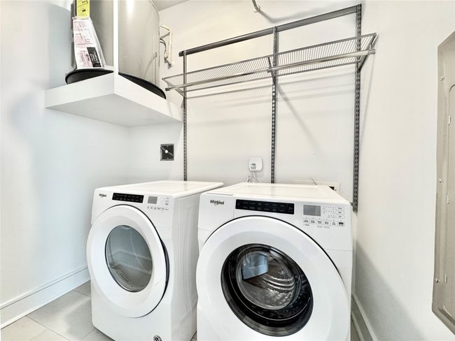 Laundry room with independent washer and dryer, baseboards, and light tile patterned flooring | Image 26