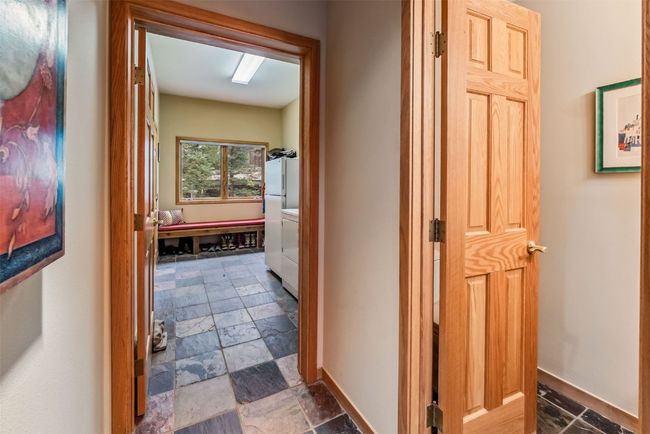 Hallway between entry, primary, and mud/laundry room | Image 24