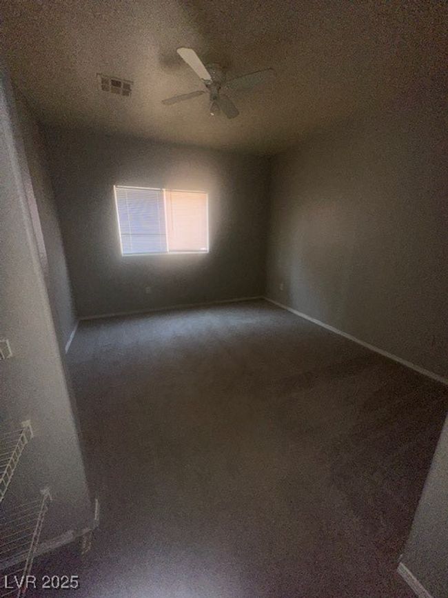 Carpeted spare room featuring a ceiling fan and baseboards | Image 8