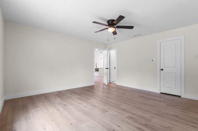Unfurnished room with a ceiling fan and light wood-style floors | Image 21