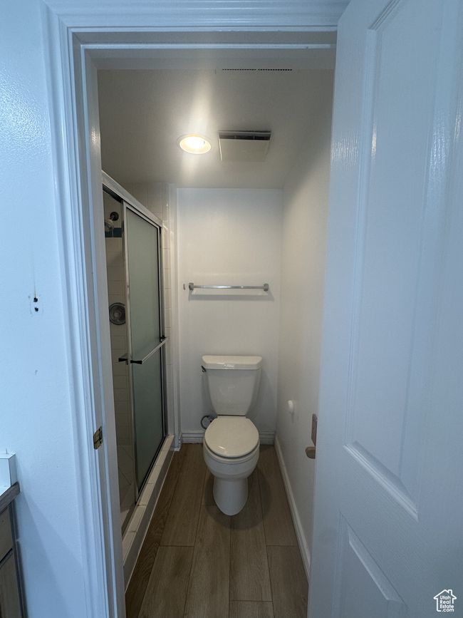 Full bathroom with a stall shower, vanity, and wood finished floors | Image 7