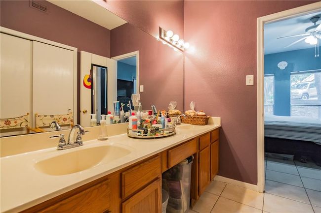 Ensuite bathroom with tile patterned floors, double vanity, and ceiling fan | Image 18