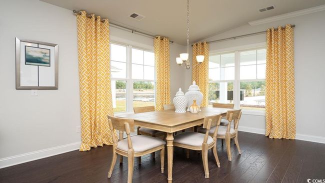 Dining space with a chandelier, baseboards, lofted ceiling, dark wood-type flooring, and visible vents | Image 16