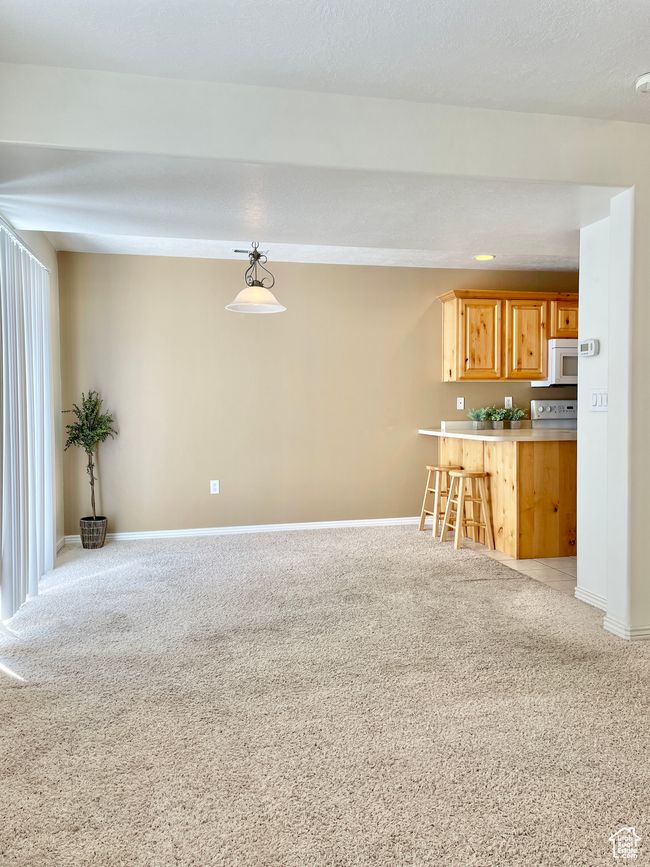 Unfurnished living room with light colored carpet and baseboards | Image 7