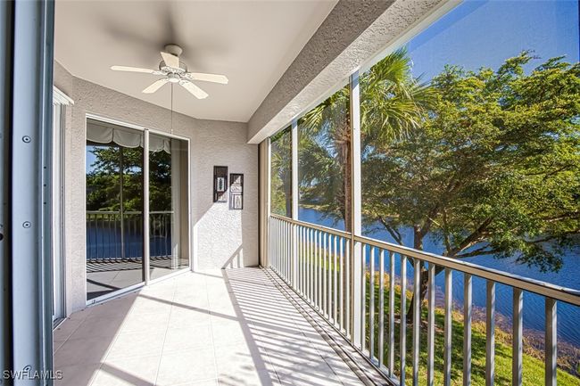 Unfurnished sunroom with ceiling fan and a water view | Image 19