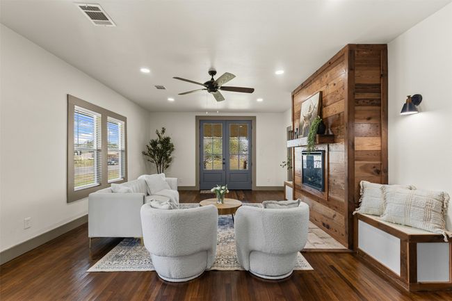 Living area featuring recessed lighting, a glass covered fireplace, baseboards, dark wood-style flooring, and ceiling fan | Image 32