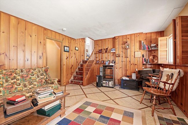 Living area with stairs and wood walls | Image 21