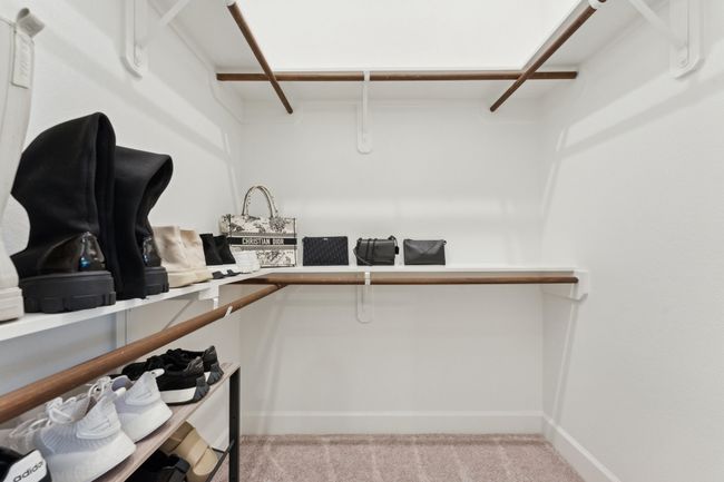 Walk in closet with light carpet | Image 23
