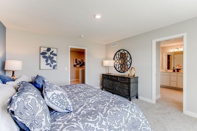 Primary Suite, shown here with a King-sized bed, the room is overly spacious and offers the perfect setting to start and finish each day in! Photos used are from a model of a similar plan/home representation. Some colors and options will vary. | Image 14