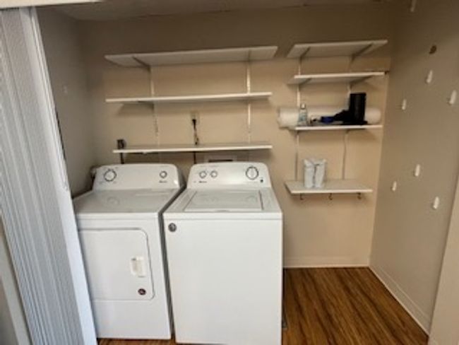 Laundry room featuring washer and clothes dryer, dark wood-style floors, and baseboards | Image 10