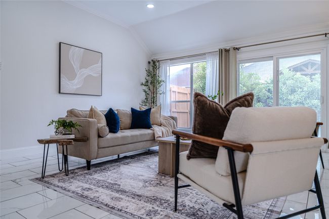 Living room with ornamental molding, marble finish flooring, recessed lighting, and lofted ceiling | Image 17
