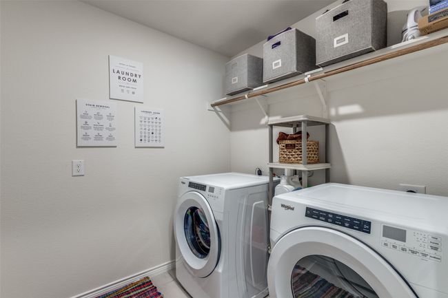 Laundry room comes equipped with washing machine and clothes dryer and ceramic tile flooring | Image 21