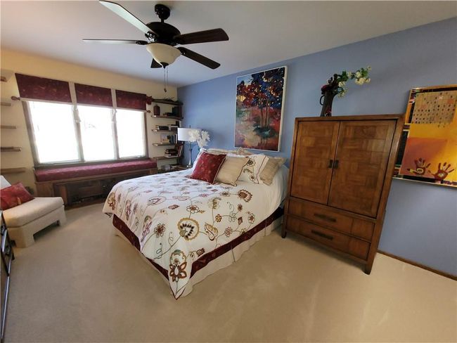 Bedroom with carpet floors and ceiling fan | Image 42