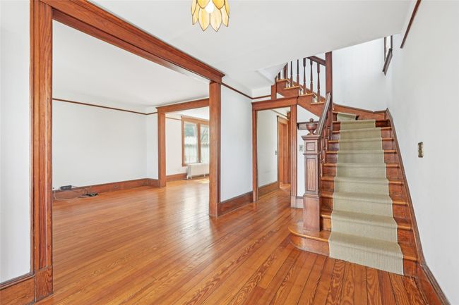 Stairs featuring hardwood / wood-style floors, radiator heating unit, and baseboards | Image 5