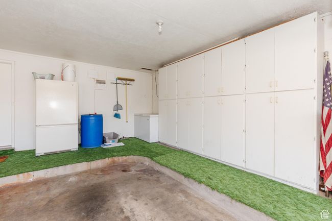 Garage featuring freestanding refrigerator | Image 34