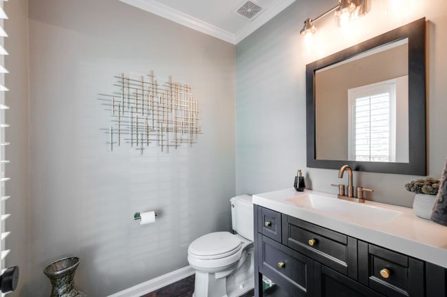 The main level powder room has also been fully renovated with a new vanity, fixtures and mirror. | Image 30