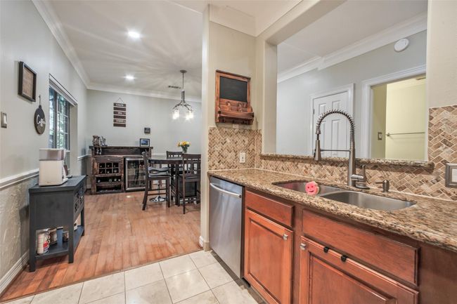 Spacious kitchen features granite countertops and stainlesss appliances. | Image 11
