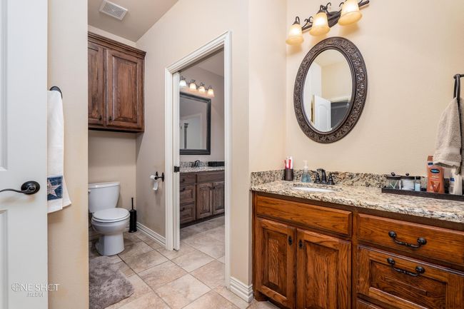 Bathroom featuring toilet, vanity, and baseboards | Image 29