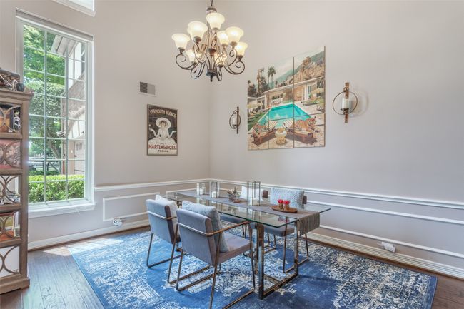 Dining room with a chandelier and tall ceilings | Image 15