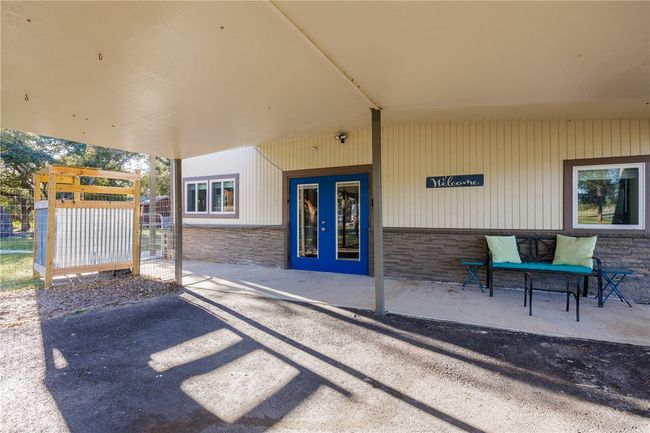 Large covered patio and parking area | Image 4
