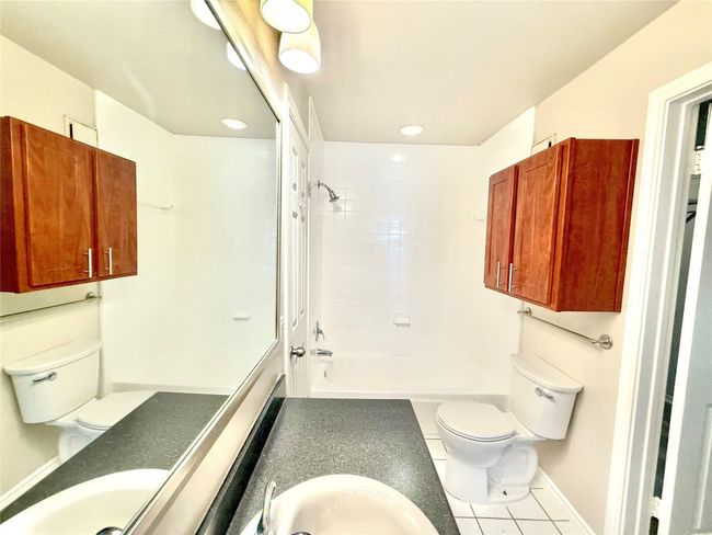 Bathroom with tile patterned floors, vanity, tub / shower combination, and recessed lighting | Image 7
