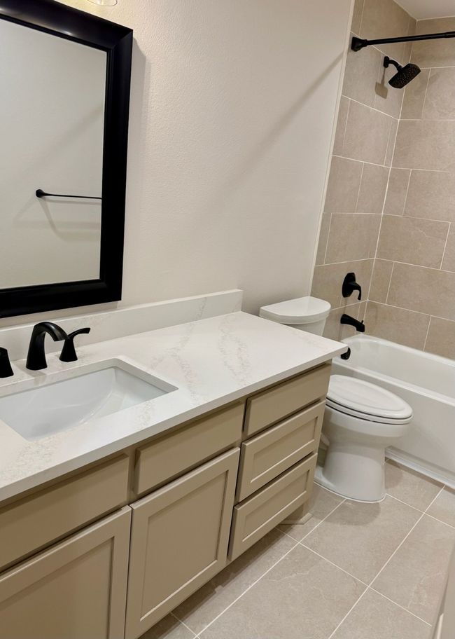 Bathroom with vanity, tile patterned flooring, and bathtub | Image 15