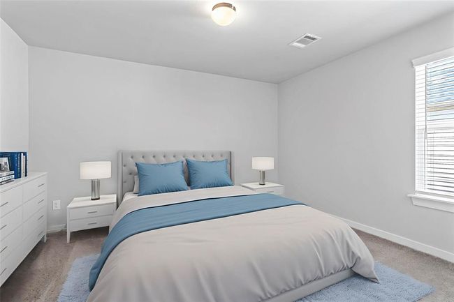 Secondary bedroom features plush carpet, custom paint, lighting, closet space, and a window with privacy blinds. | Image 18