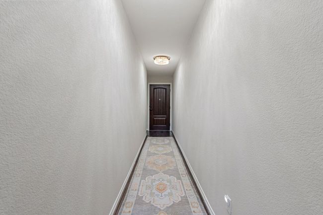 First Floor Entry Corridor featuring 2 designer flush lights, baseboards and a textured wall | Image 33