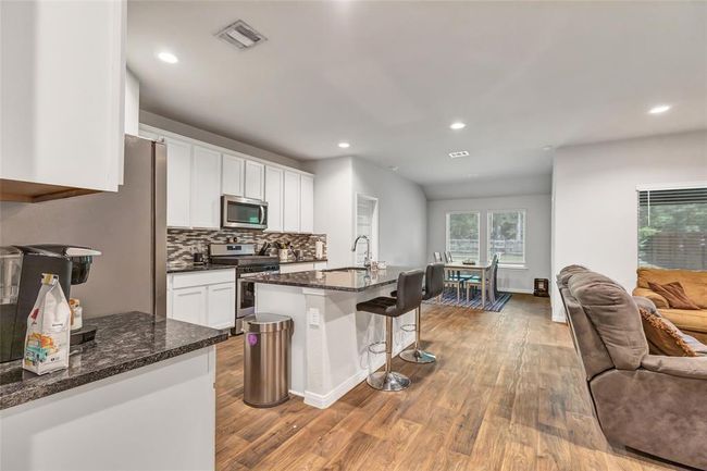 View of kitchen living and dining. Classic and timeless flooring | Image 17