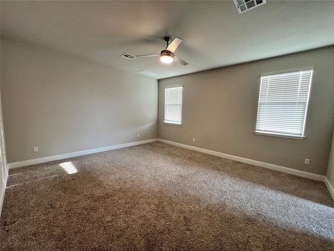 Spare room featuring ceiling fan and carpet | Image 5