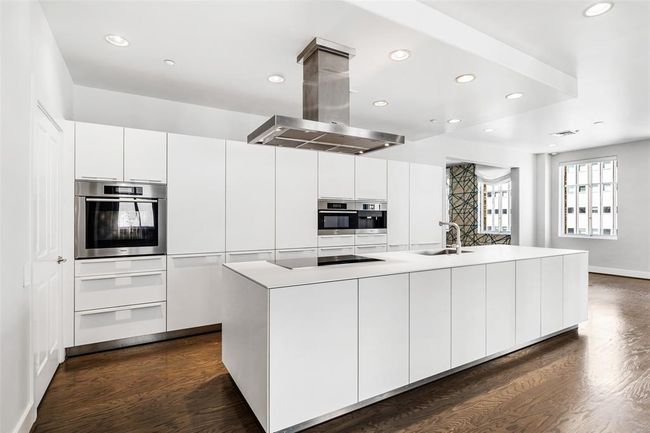 Stainless Steel appliances and wood paneled refrigerator. | Image 13