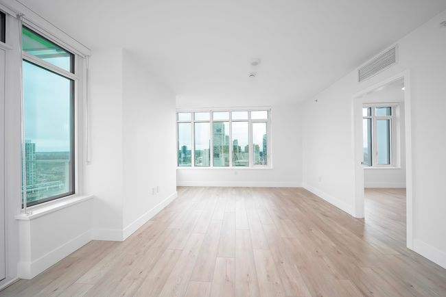 Spare room with baseboards, visible vents, and light wood-style flooring | Image 6