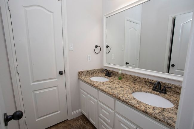 Fourth bedroom or gameroom with extral living space featuring carpet floors and ceiling fan | Image 15