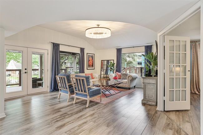 Elegant living area with oversized windows allowing you to enjoy the spacious lot and lush landscaping | Image 16