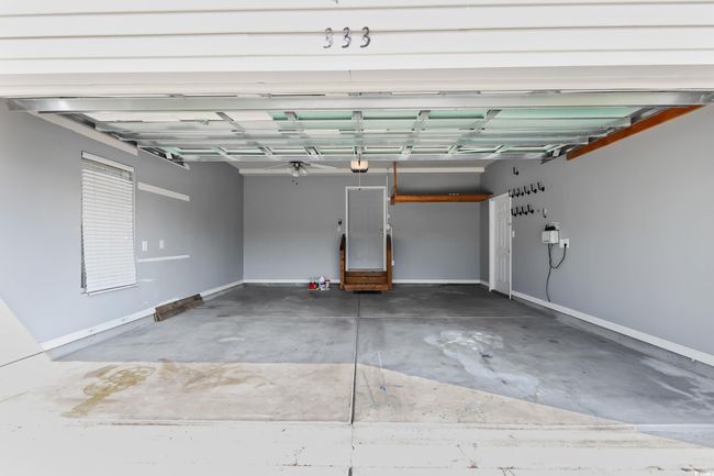 Garage featuring baseboards and a garage door opener | Image 26