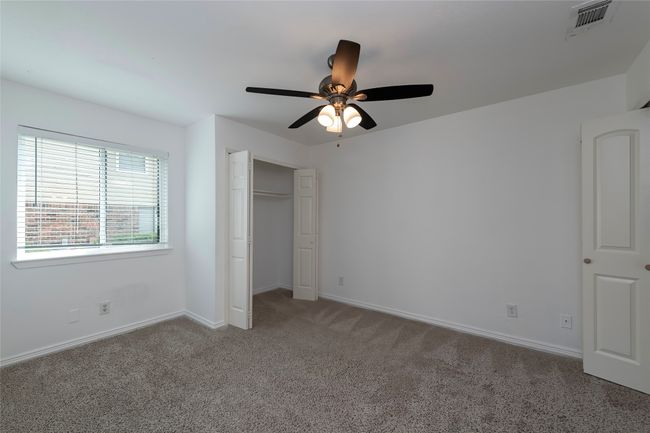 Unfurnished bedroom with a closet, visible vents, baseboards, and carpet | Image 10