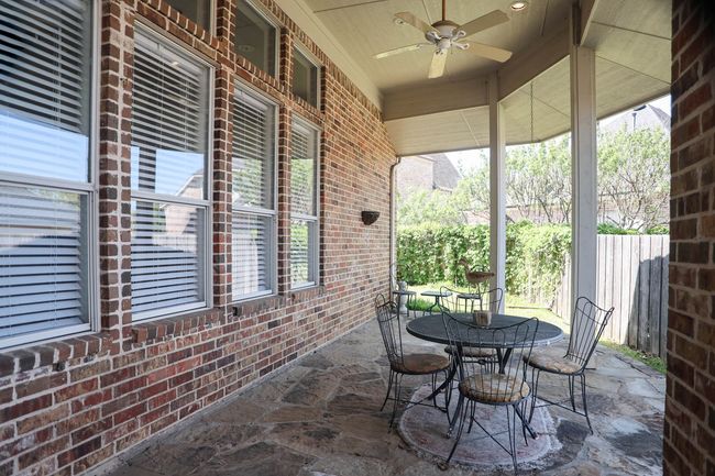 View of private patio with fence and ceiling fan | Image 25